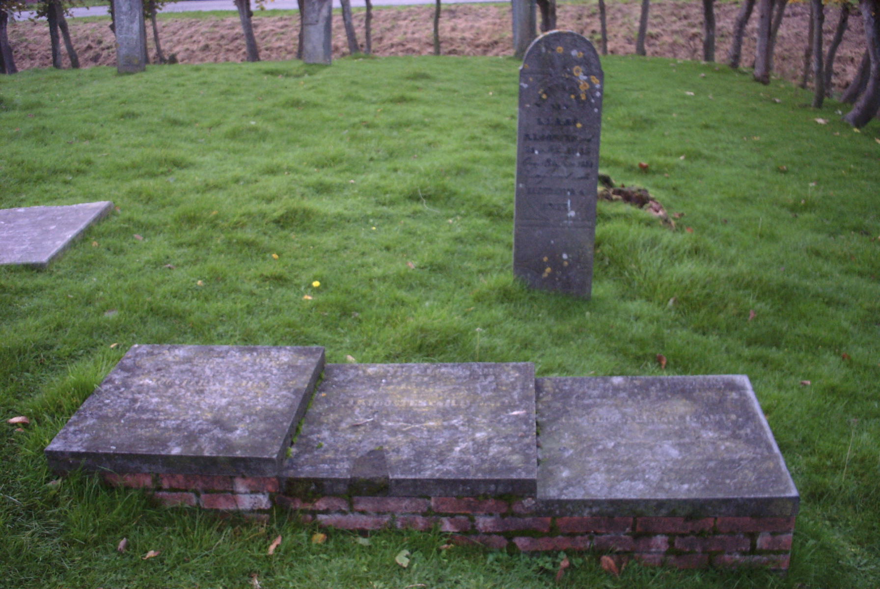 Gravestones of Antje, Hilbrand and Antje, children of Klaas Jans Klooster and Hinderika Hindriks Smit, the gravestone of Klaas Jans Klooster in the background, at Westerdijkshorn near Bedum. 